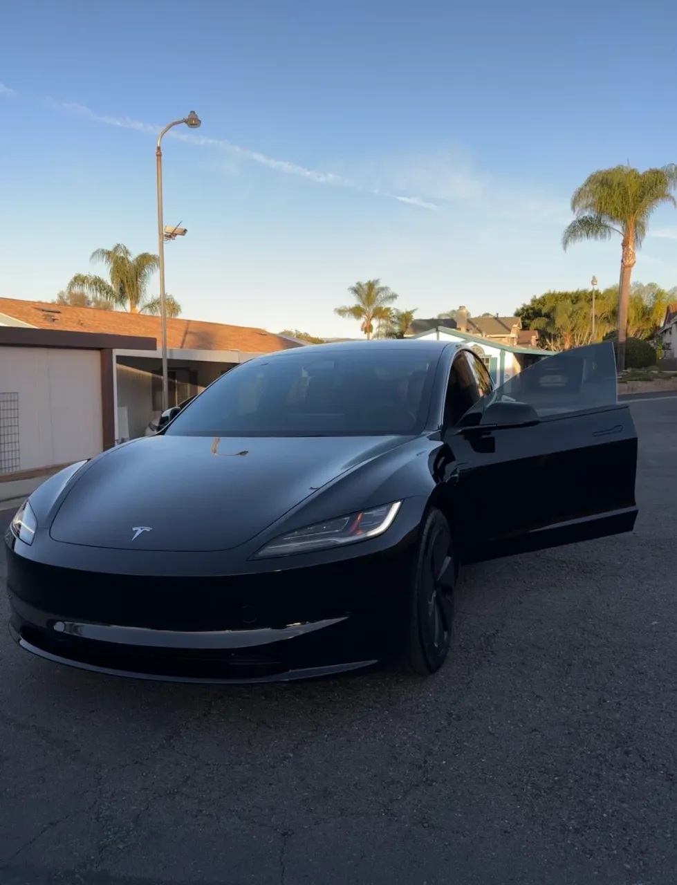2025 Tesla Model 3 exterior after complete detail — mirror-finish black paint